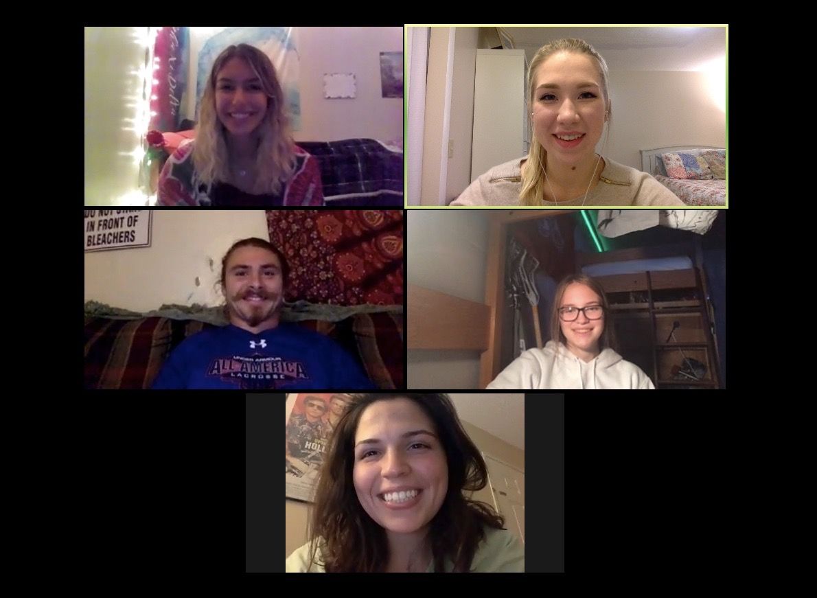 Five people smiling on a video call. Different settings, with some decorated, bright backgrounds.