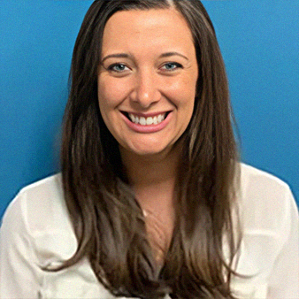 Woman with brown hair smiles, wearing white shirt, blue background.