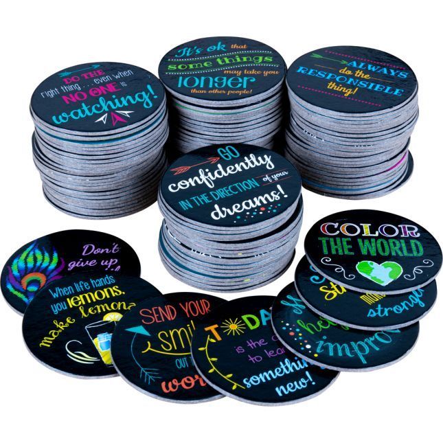 Stacks of motivational quote coasters with colorful text on black backgrounds.