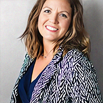 Woman with brown hair smiles, wearing a patterned jacket over a navy top.