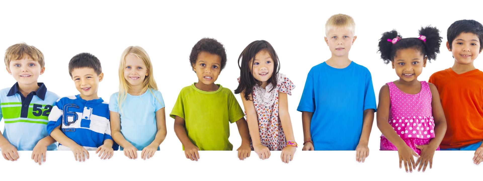 Children of various ethnicities holding a white surface, smiling.