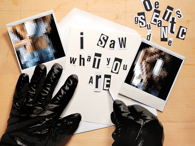 Hands in black gloves arrange letters on a note that reads