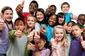 Group of diverse children smiling, giving thumbs up.