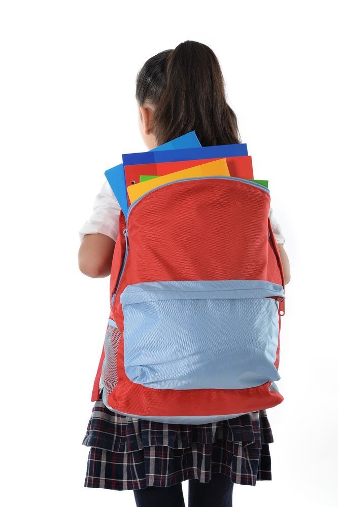 Girl with red backpack, facing away, holding colorful folders.