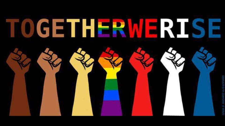Diverse fists raised in solidarity under the words
