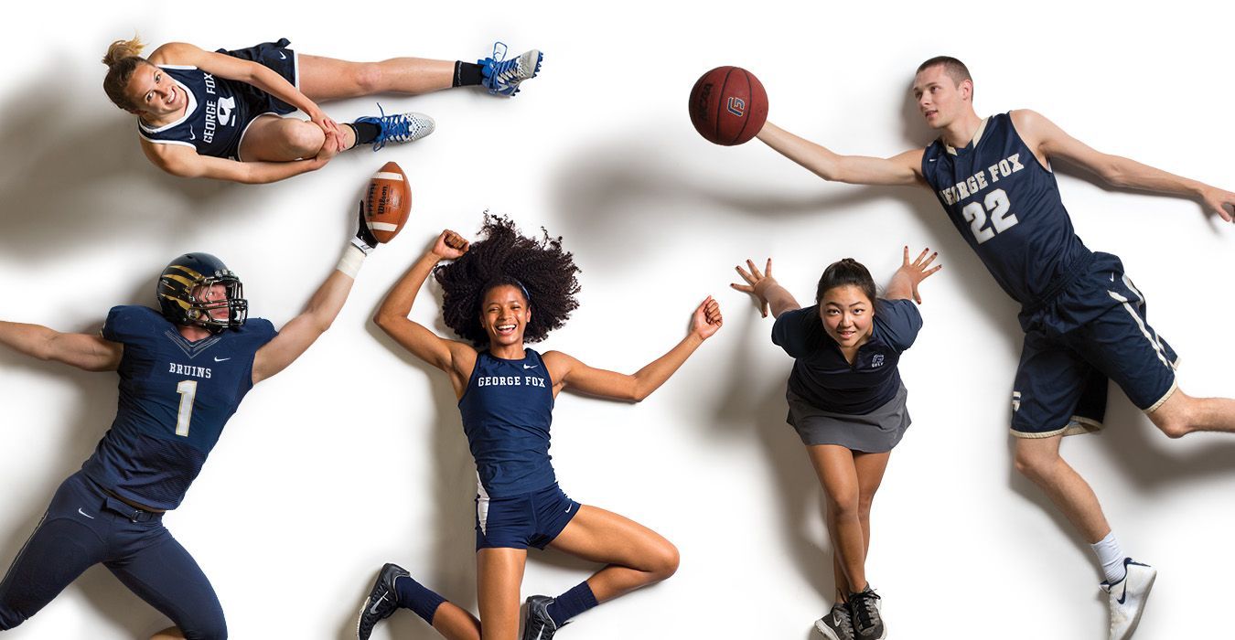 Athletes in blue uniforms posing on white; basketball, football, track, and soccer represented.