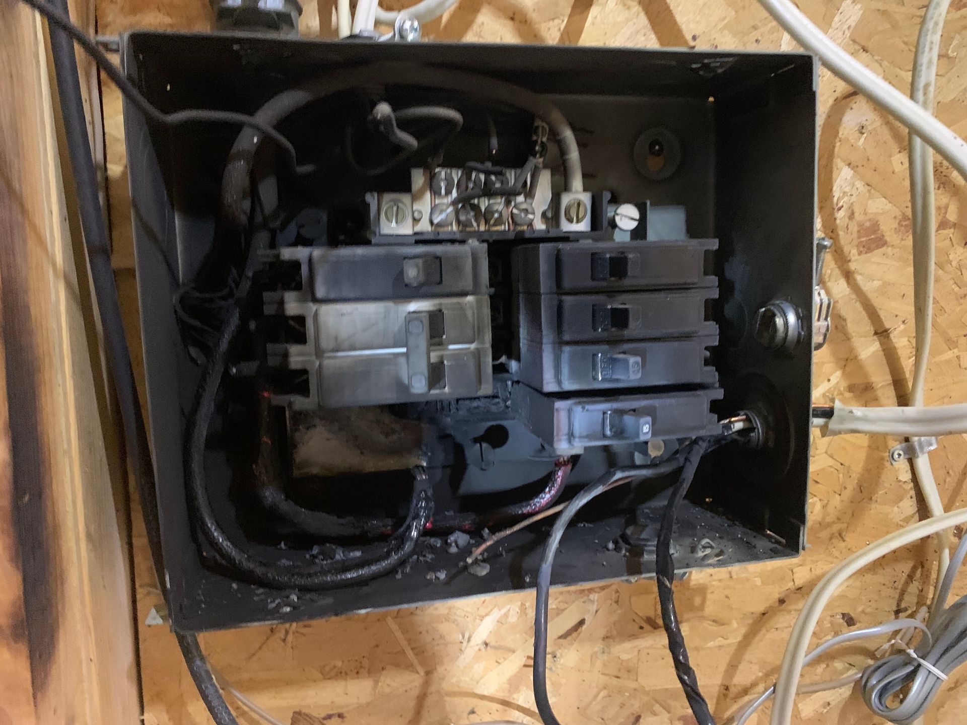A close up of an electrical box with wires coming out of it.