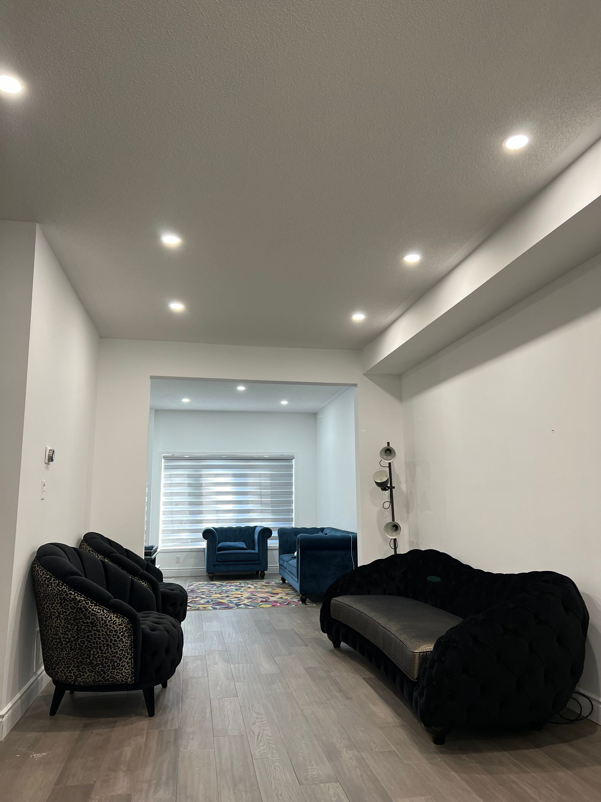 A living room with a couch and chairs in it