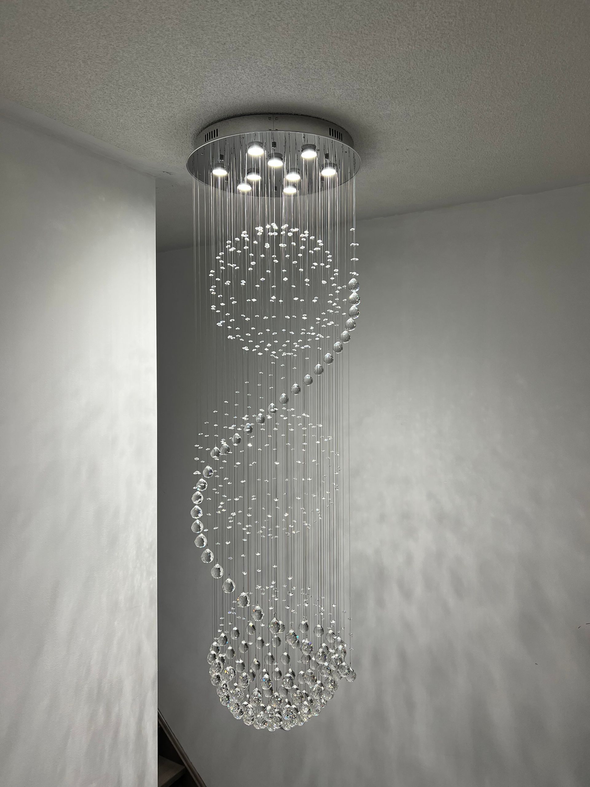 A chandelier is hanging from the ceiling in a room