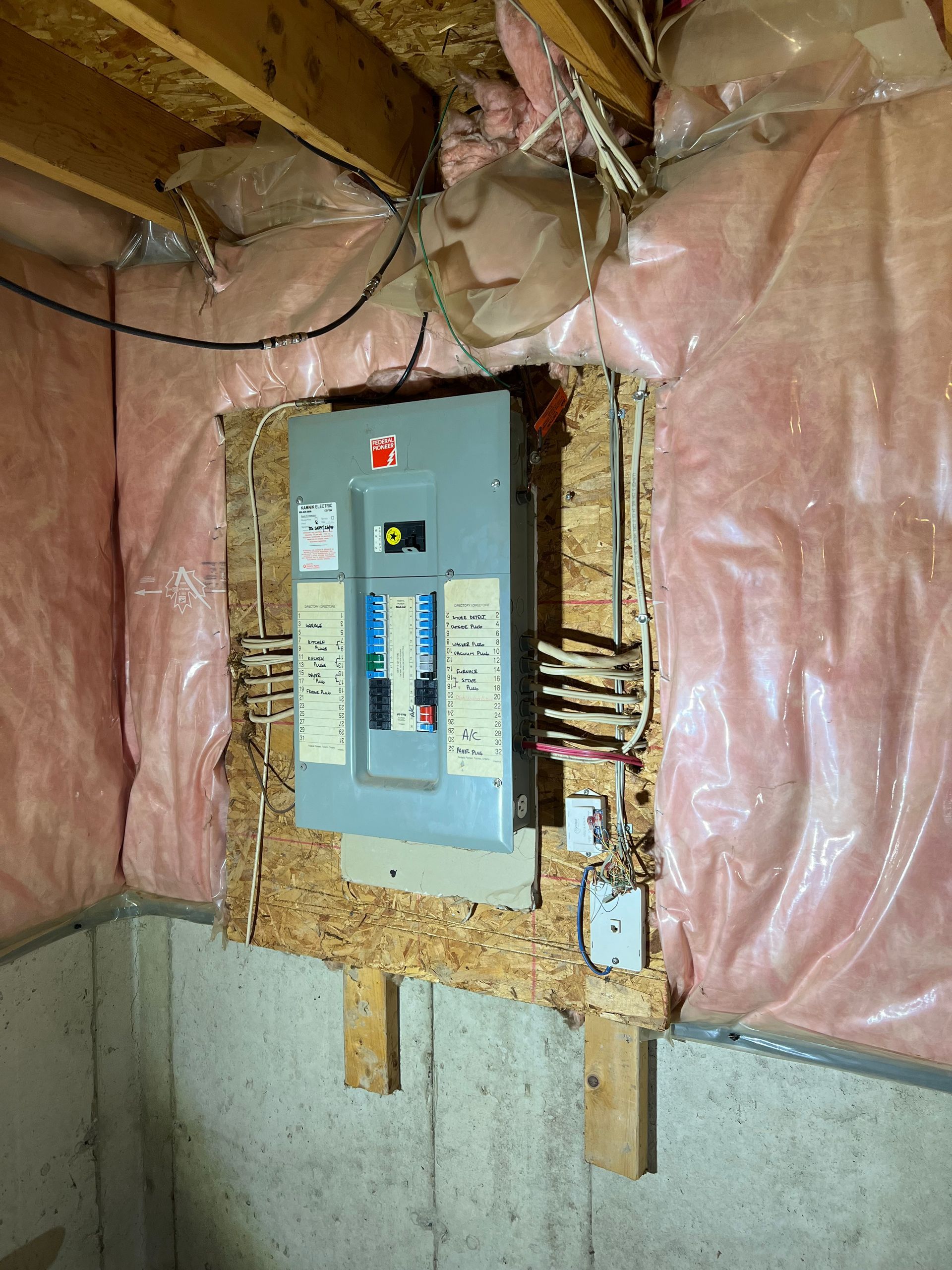 A electrical box is mounted to a wall in a room.