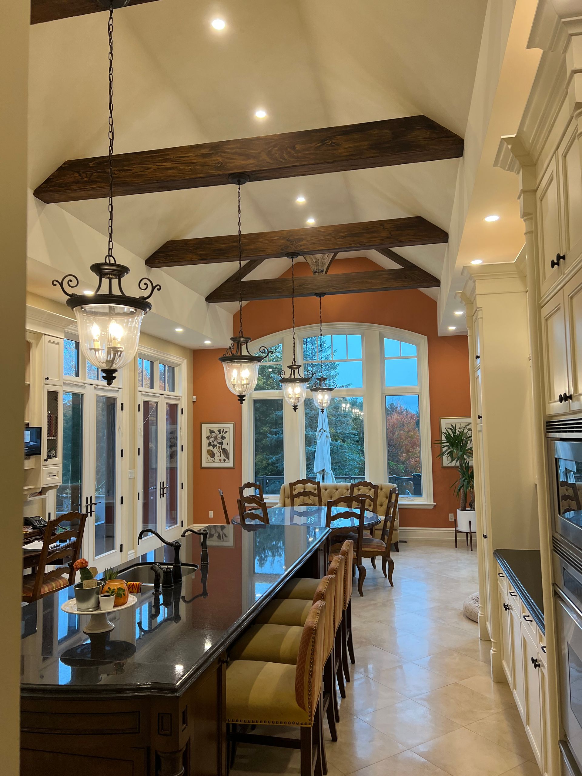 A kitchen with a dining table and chairs in it