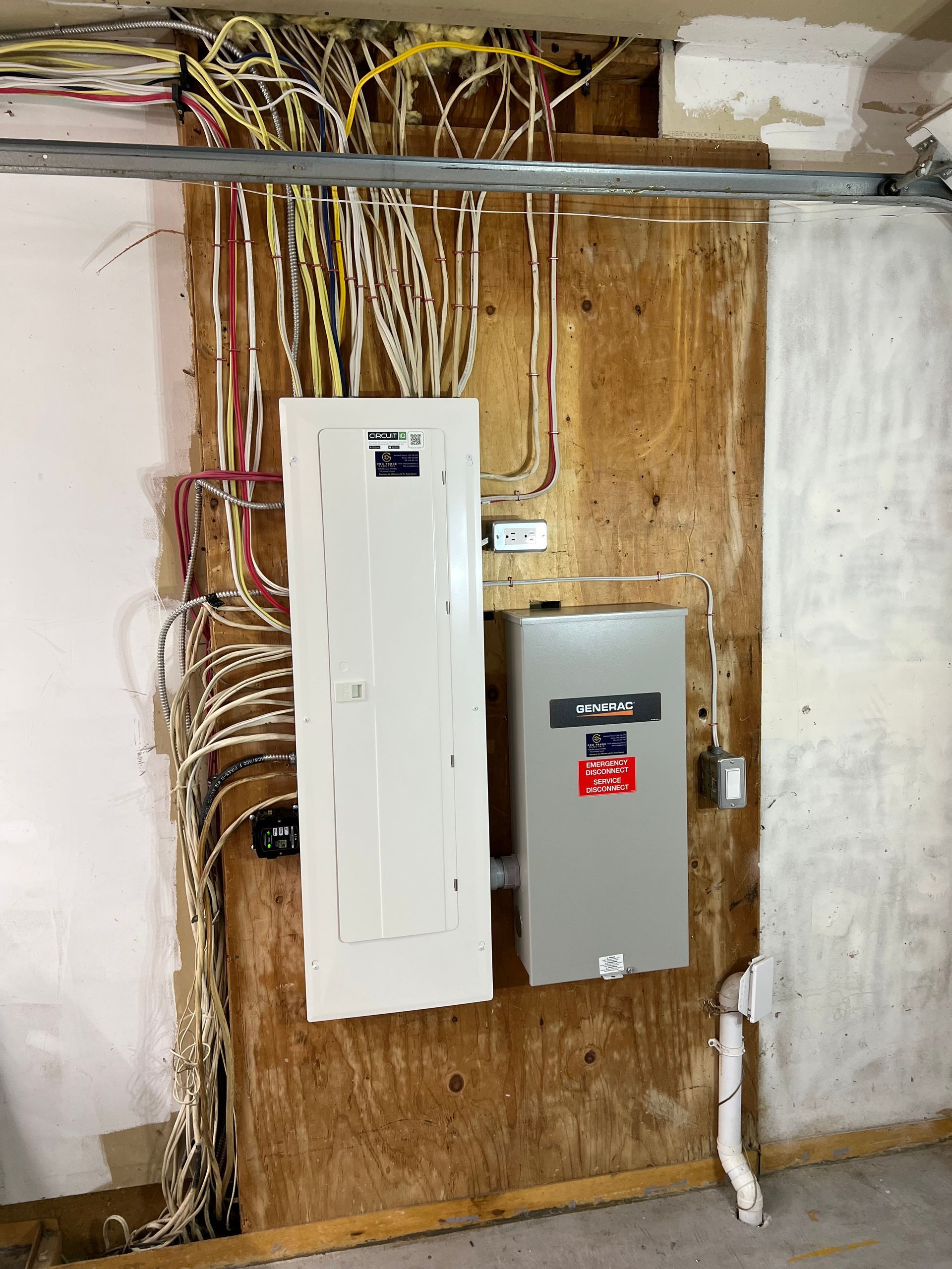 A white electrical box is hanging on a wooden wall.
