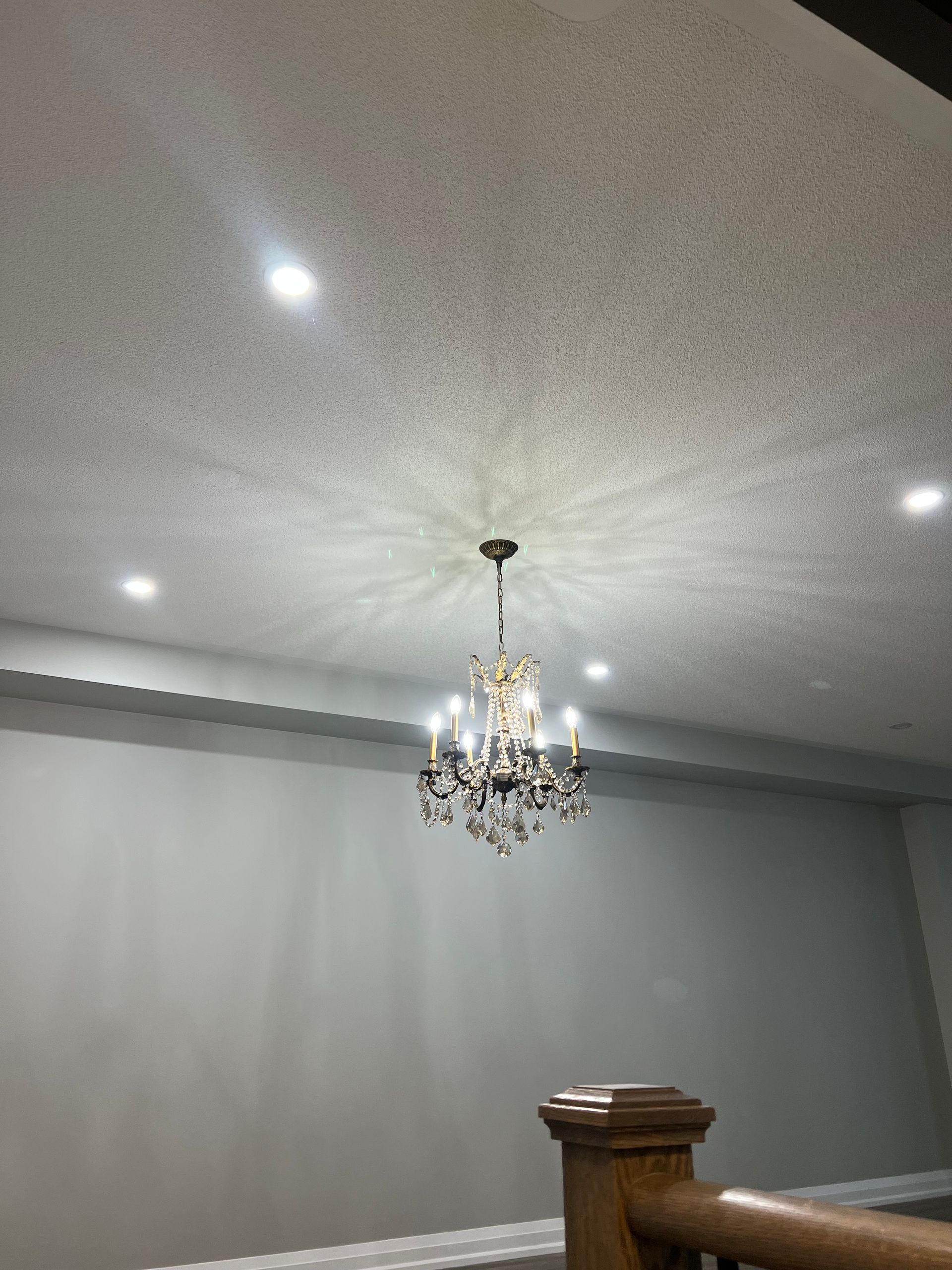 A chandelier is hanging from the ceiling of a room.