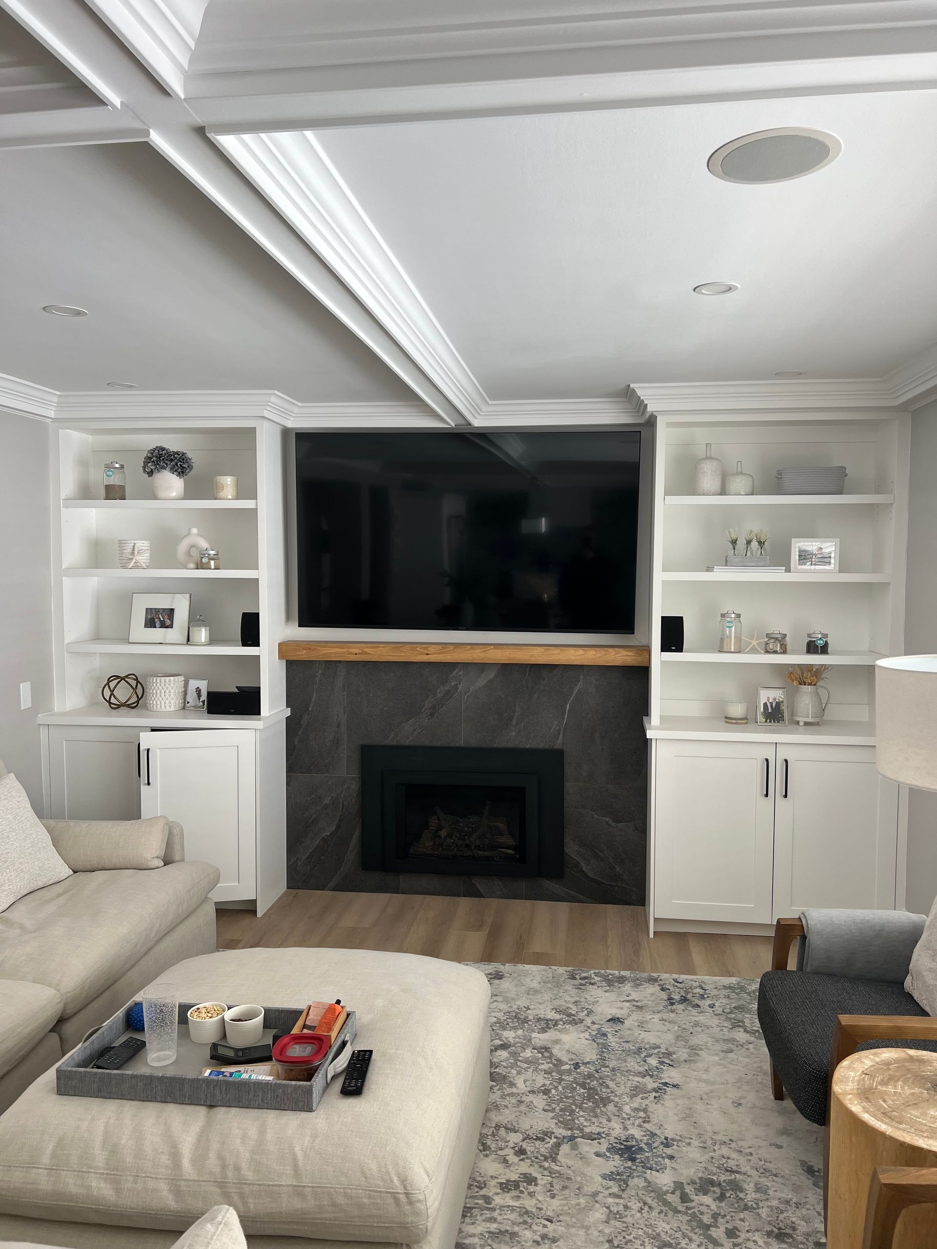 A living room with a fireplace and a flat screen tv