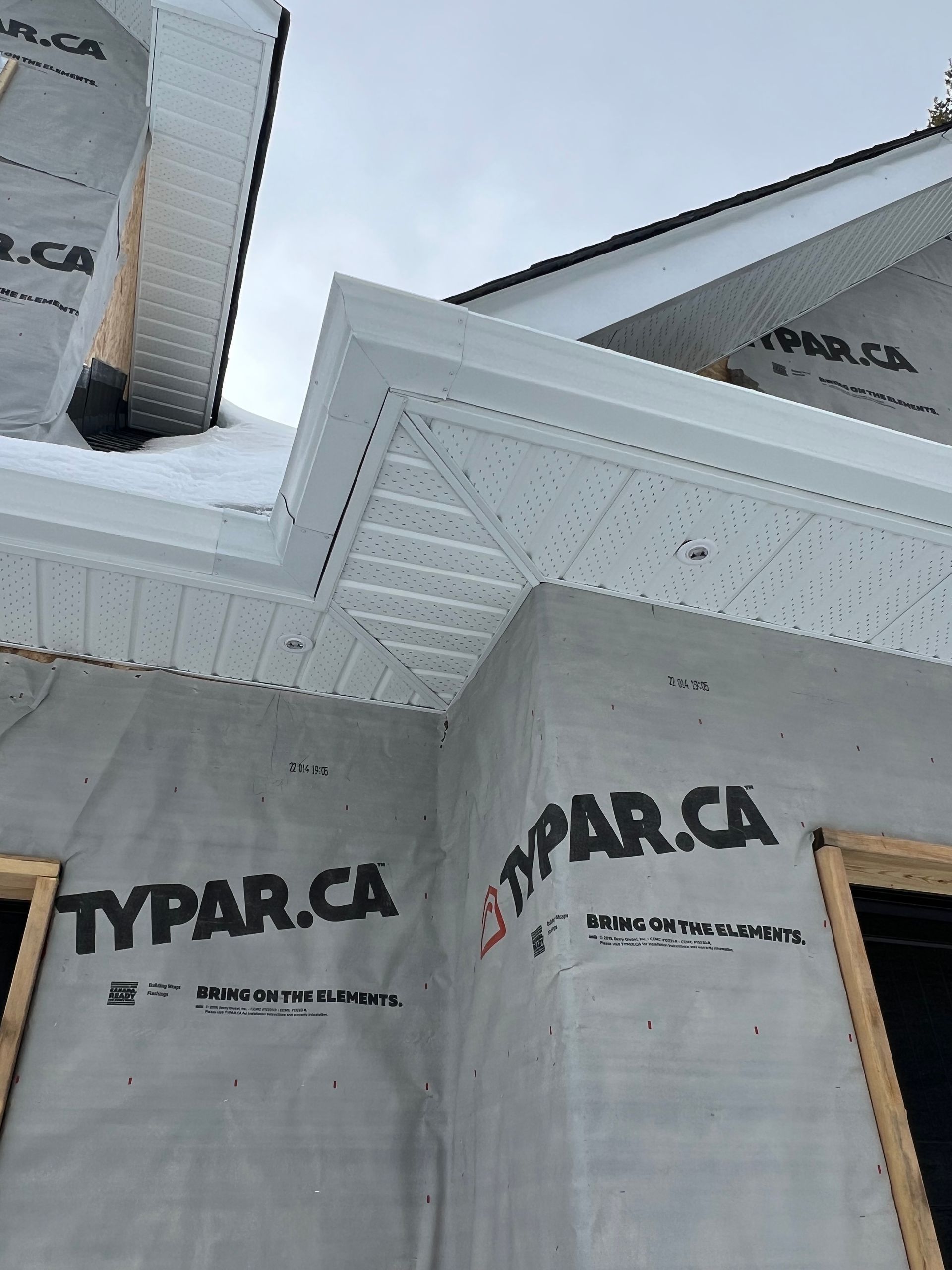 A house is being built with styrofoam on the side of it.