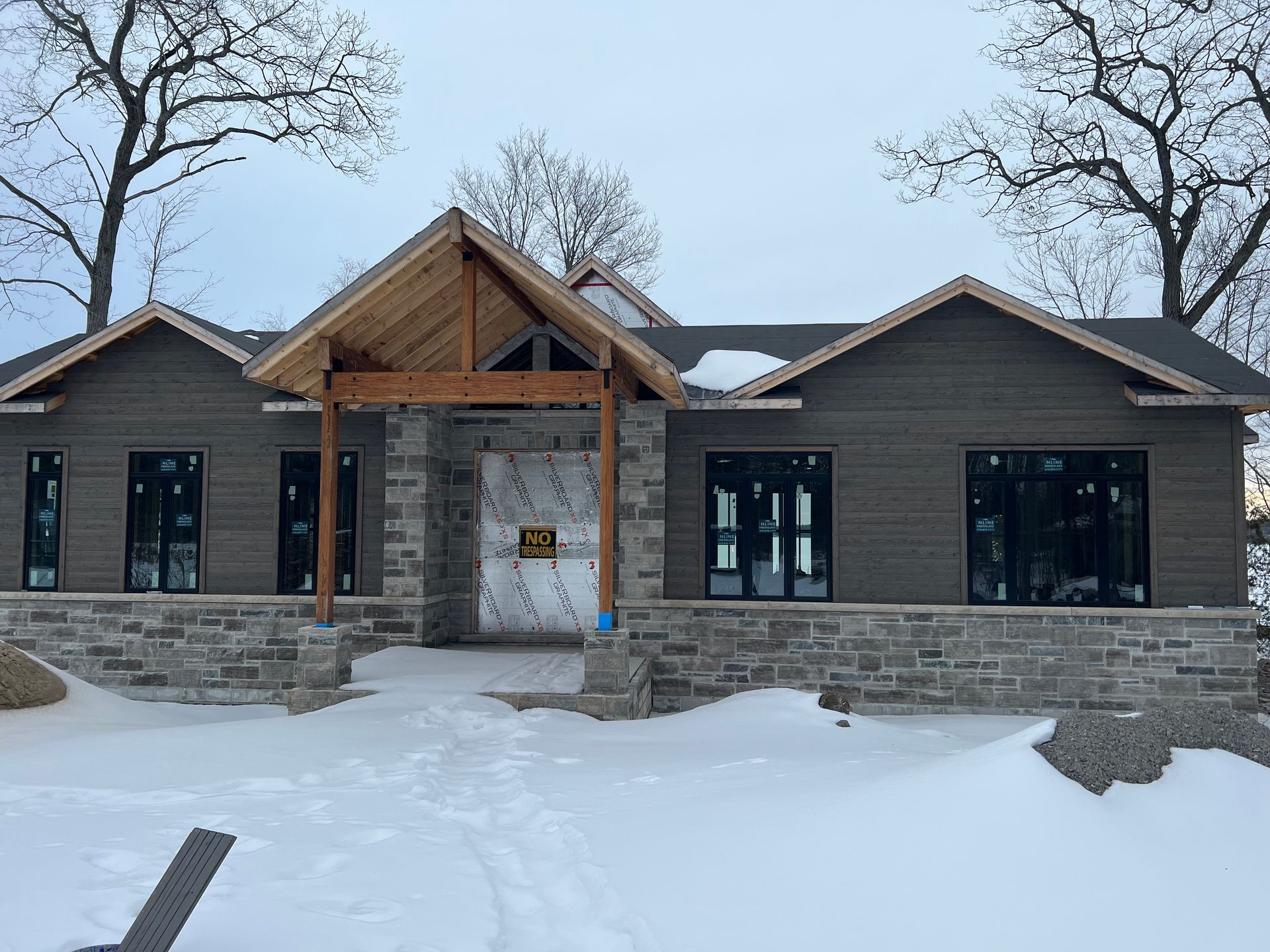 A large house is being built in the snow.