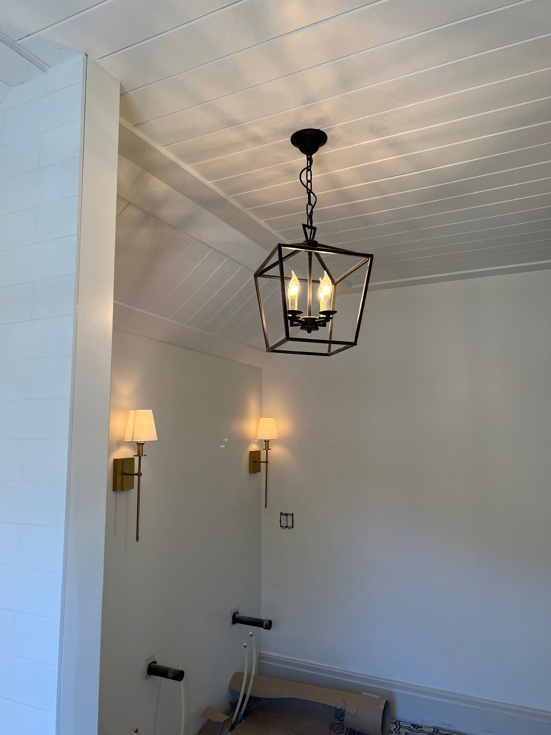 A chandelier is hanging from the ceiling of a room.