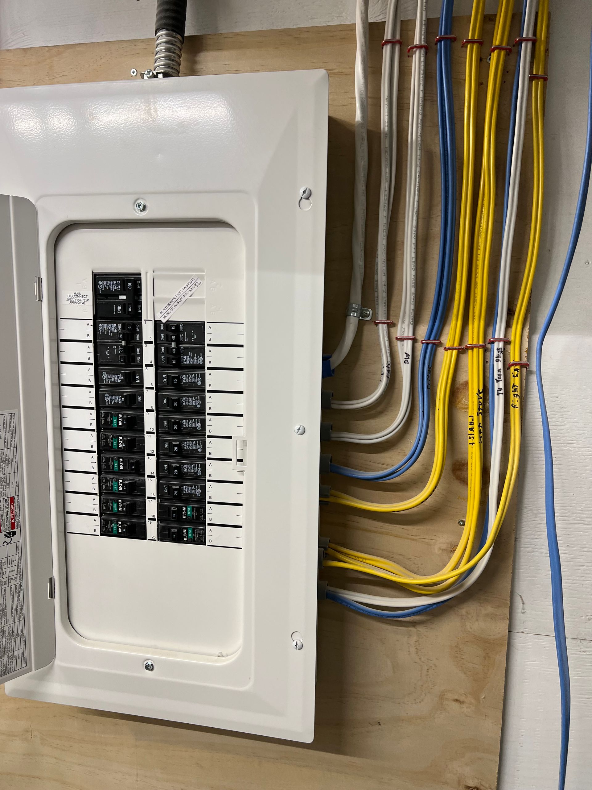 A white electrical box with a bunch of wires coming out of it.