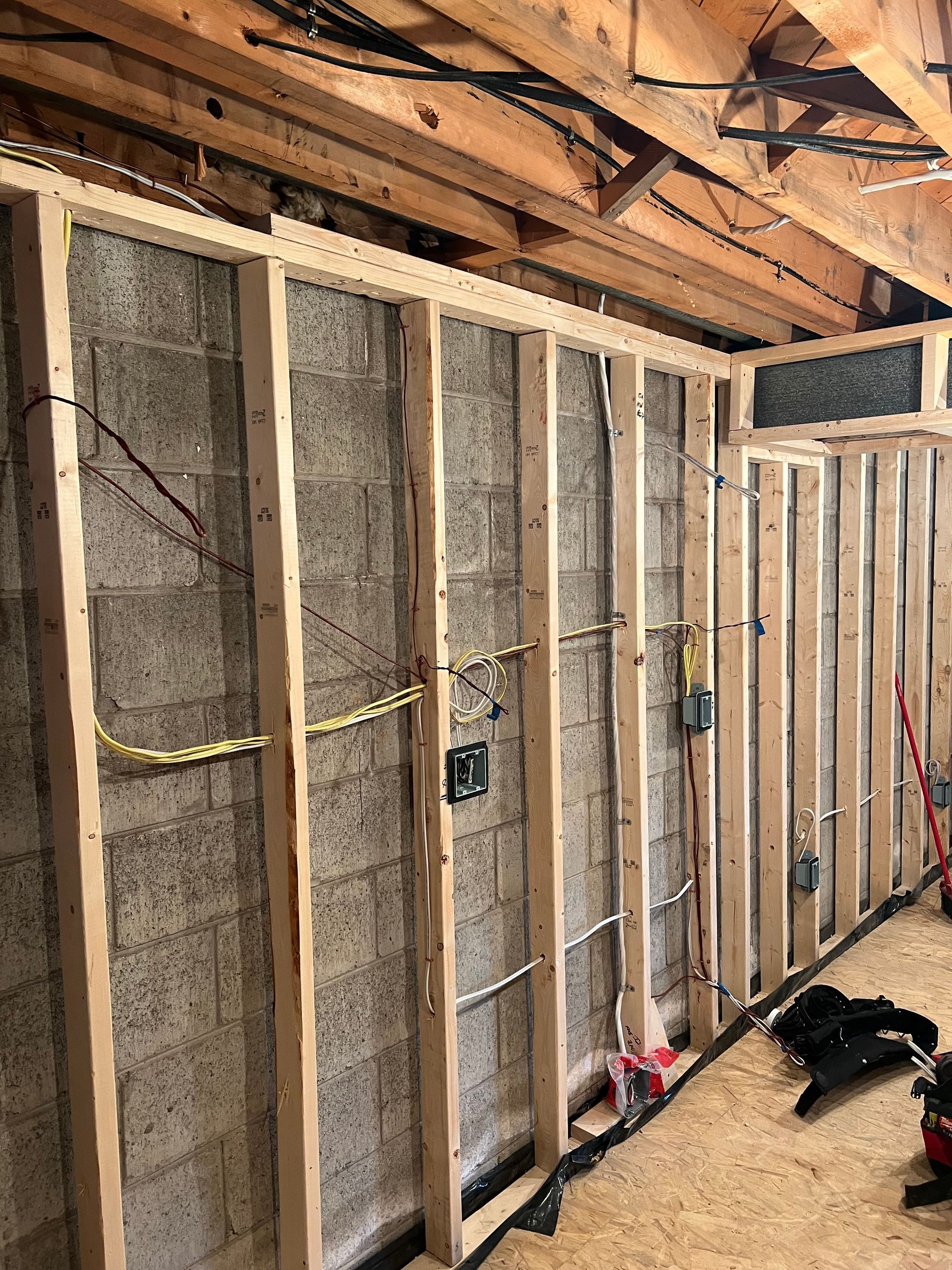 A wooden frame is being built on a brick wall.