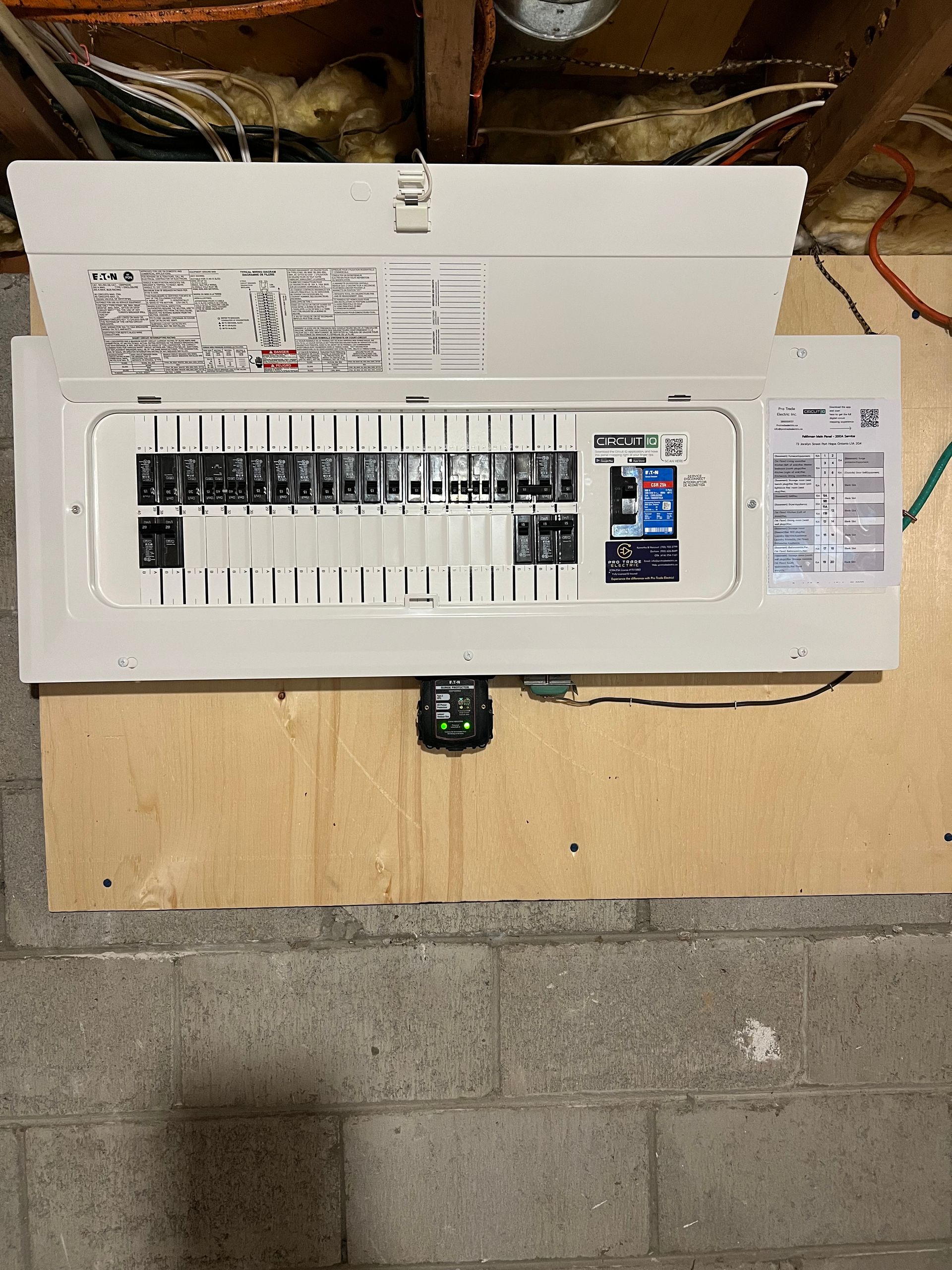 A white electrical box is sitting on top of a wooden table.