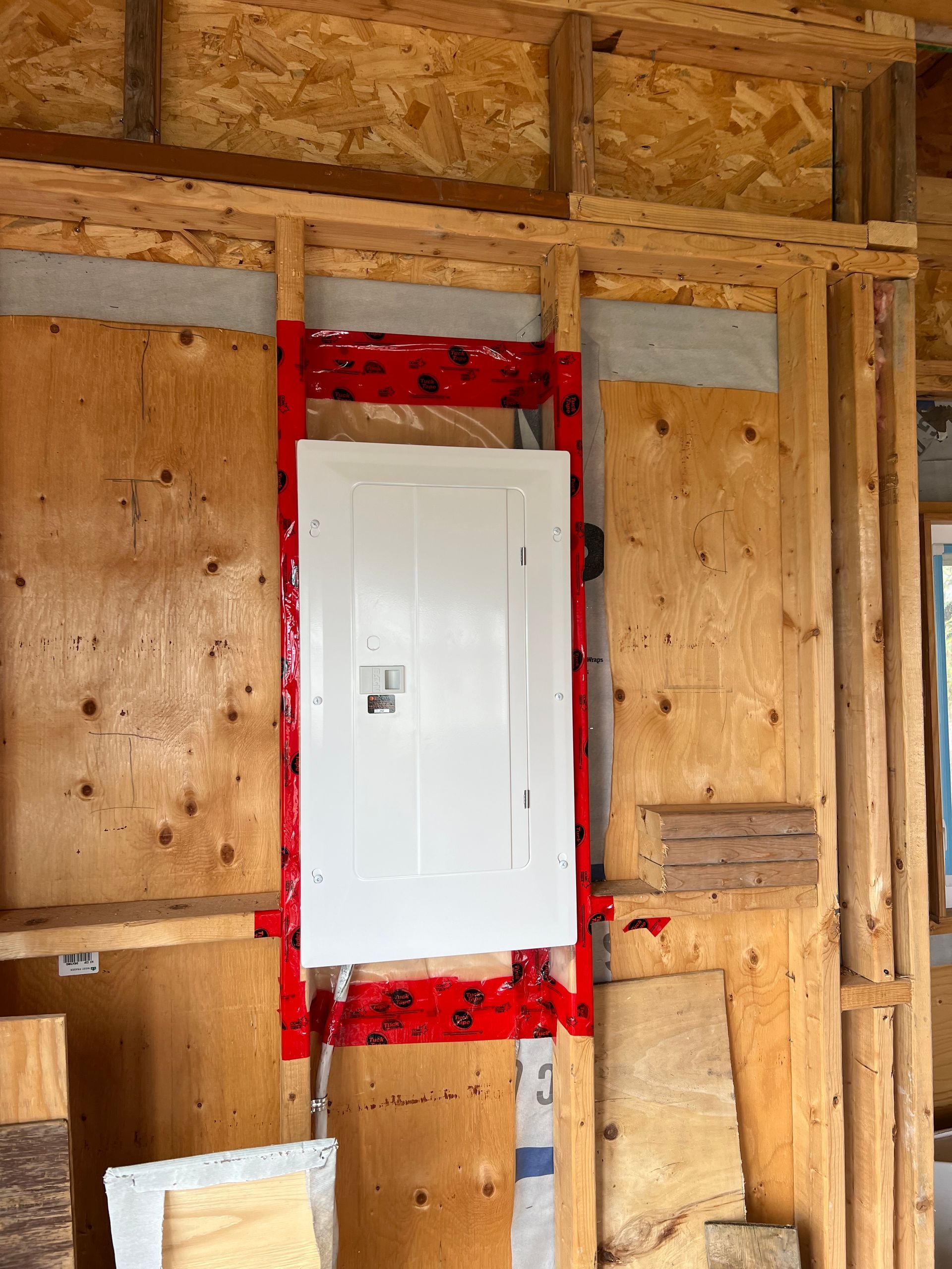 A wooden wall with a white box in the middle of it.