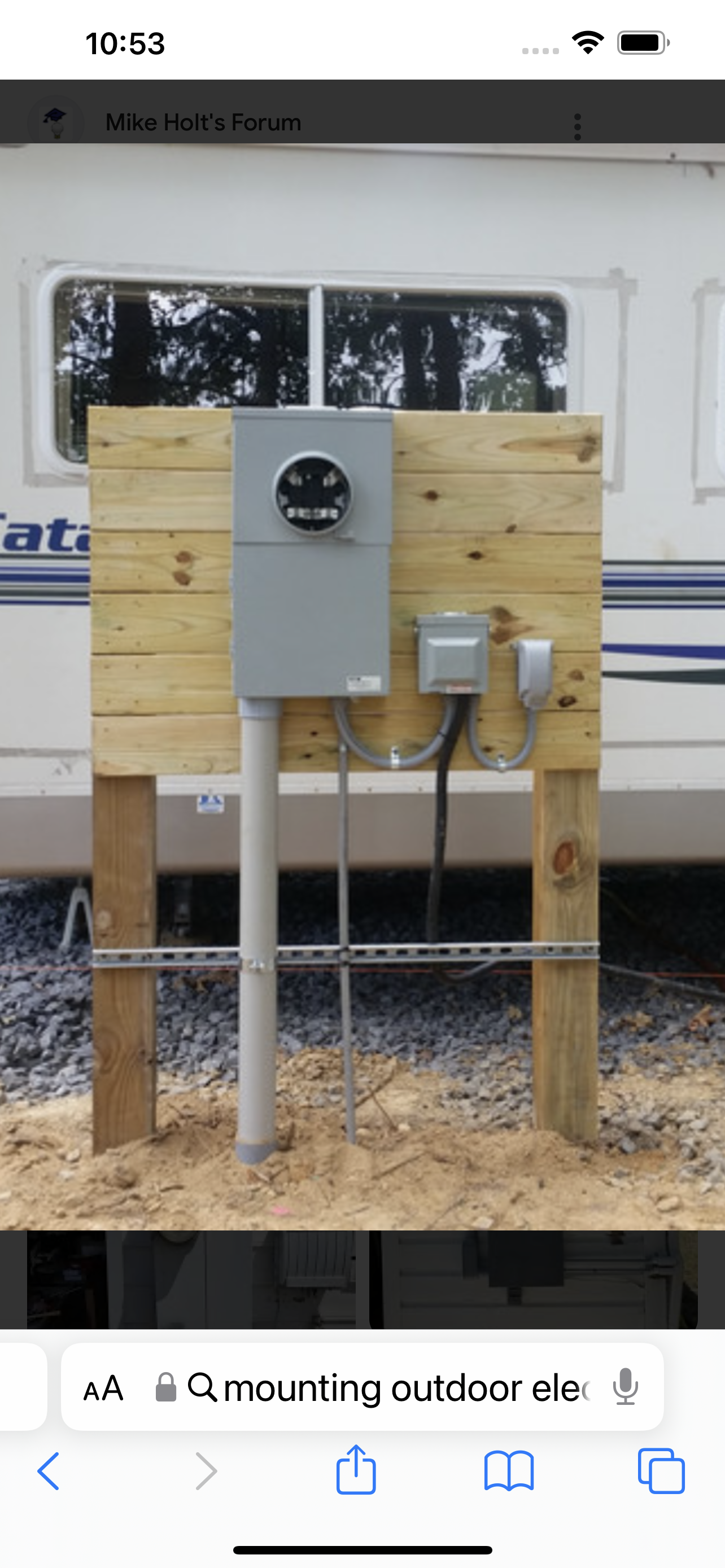 A picture of a wooden fence with a electrical box attached to it.