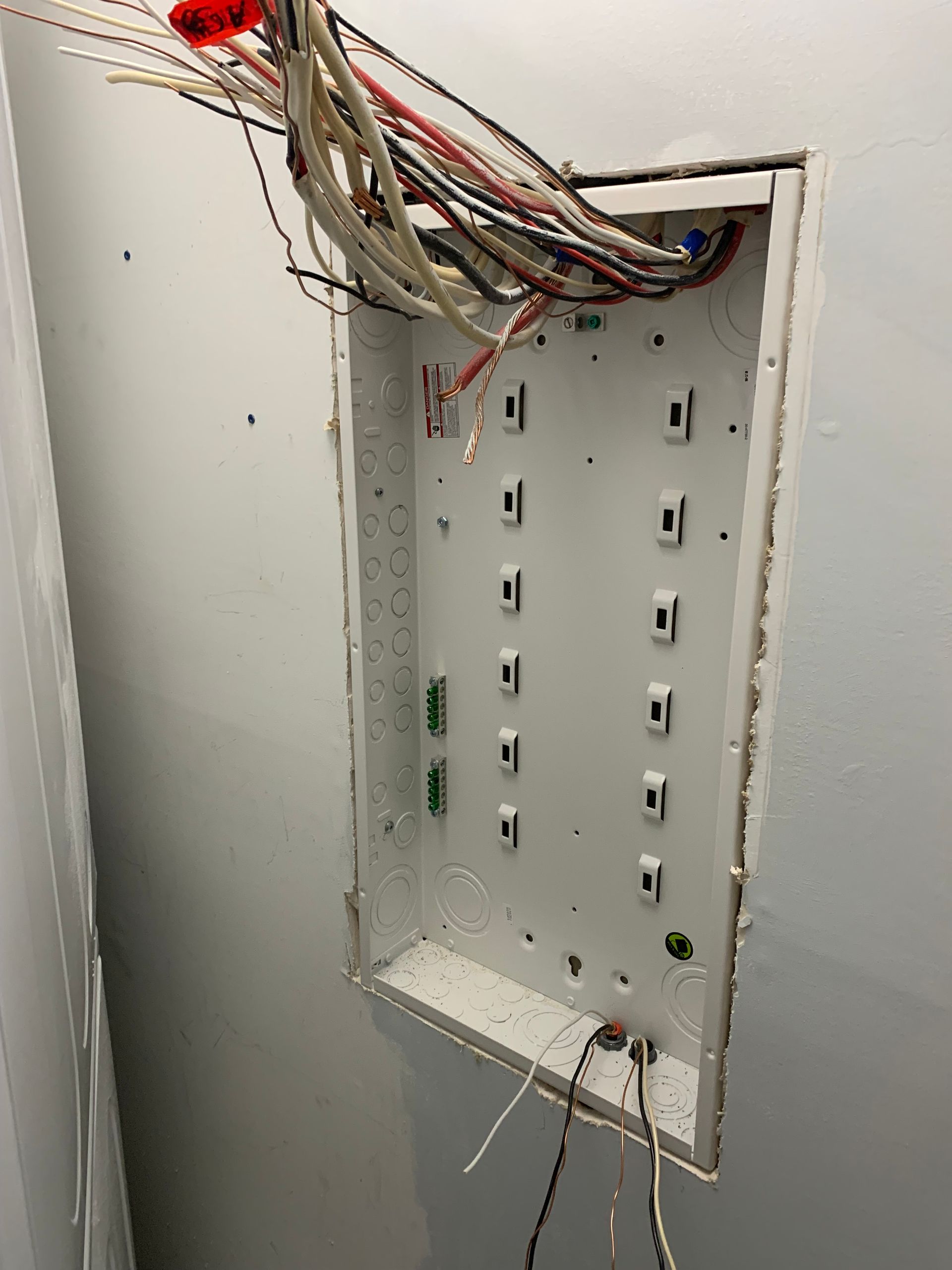 A white box with a bunch of wires coming out of it.