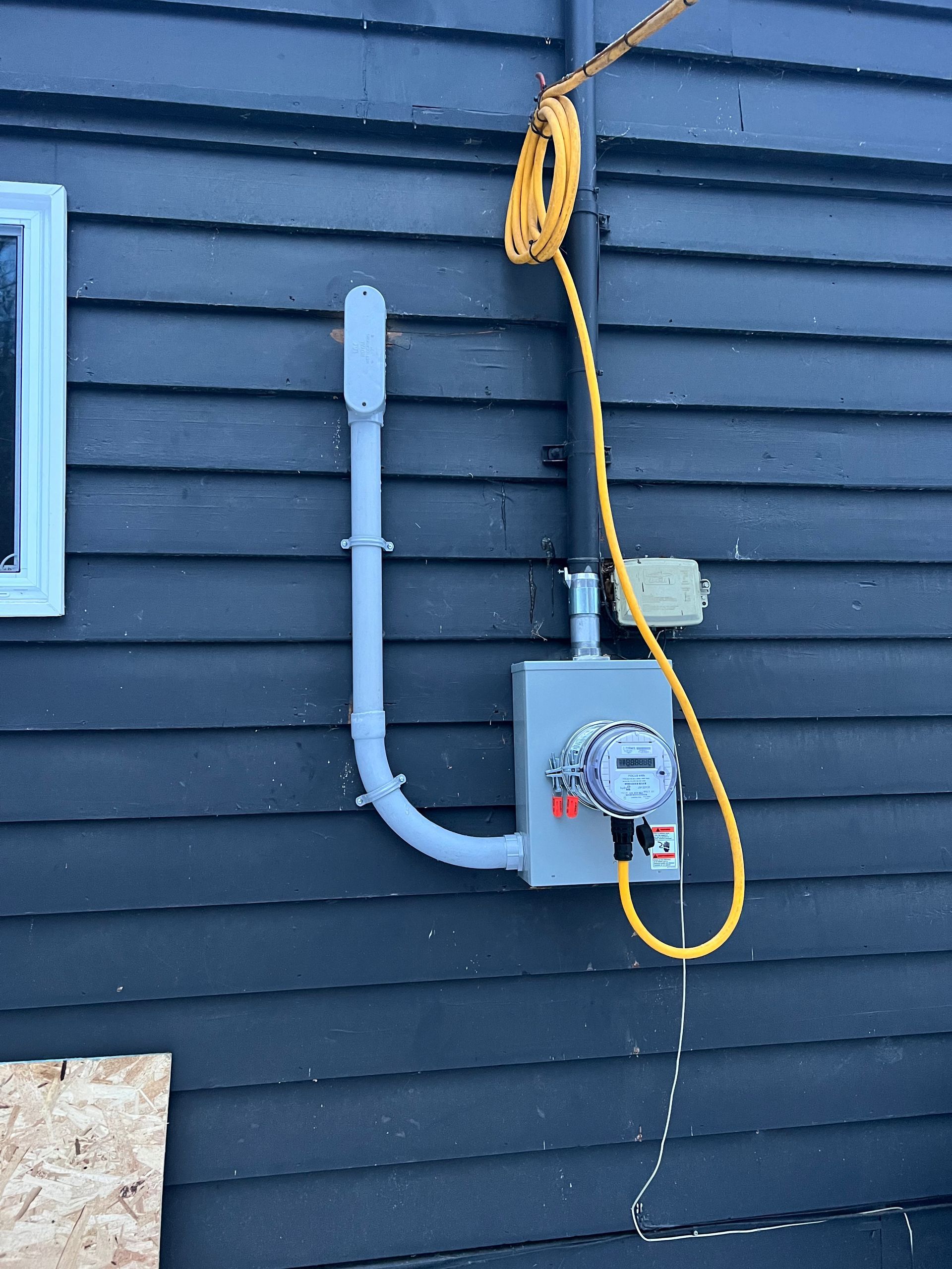 A meter is attached to the side of a house
