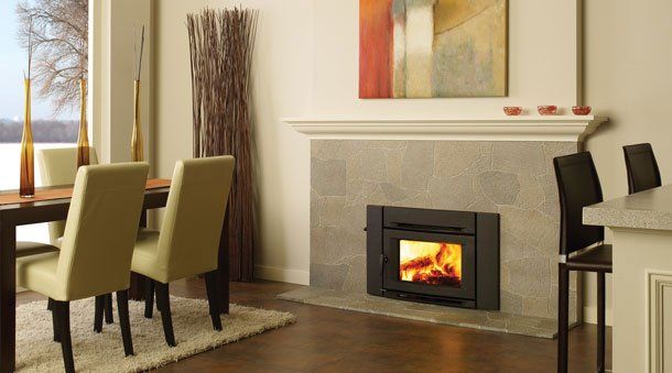 Fancy house with wood insert next to table and seats — Freehold, NJ — Fireside Pros