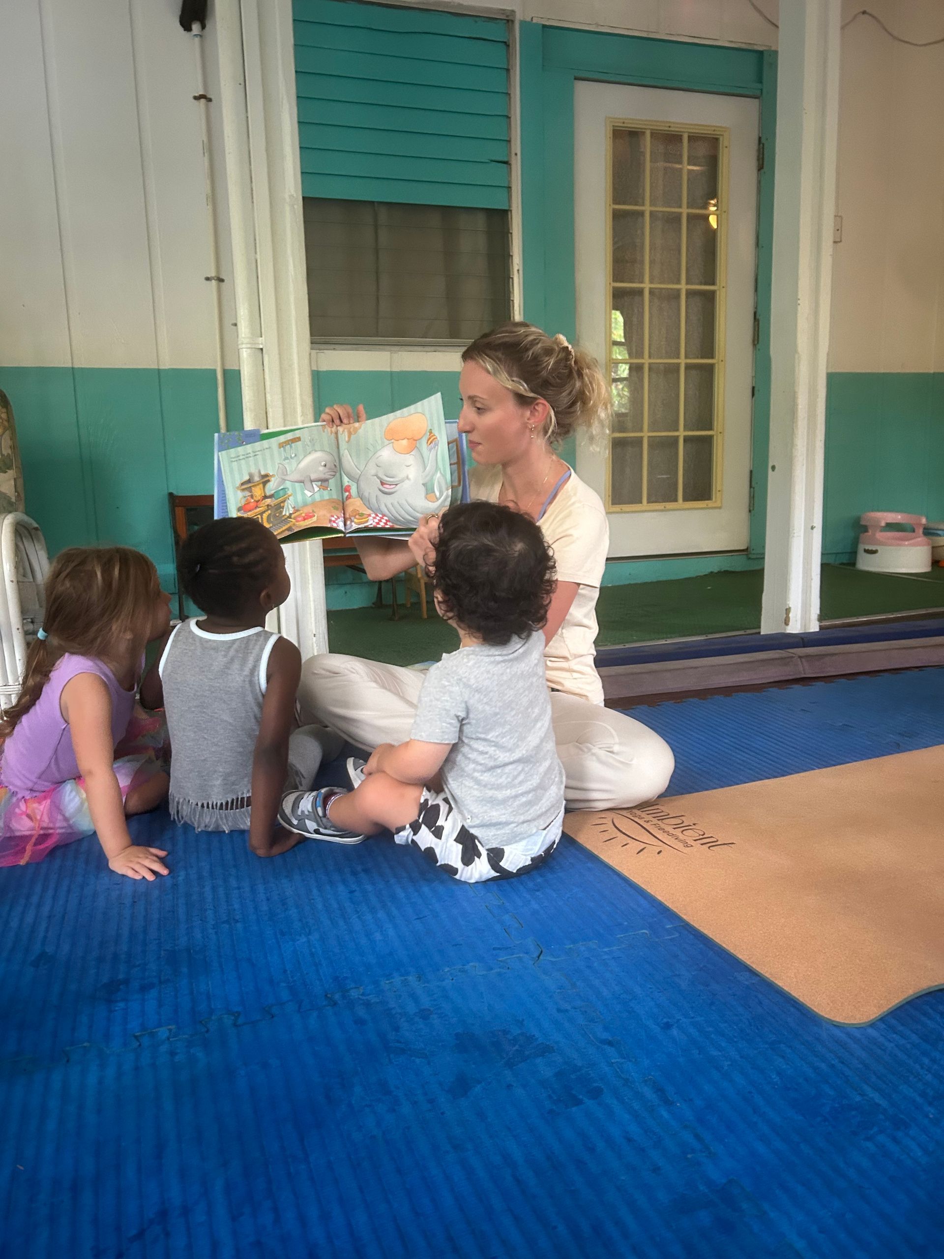 Miss Meg reading to the kids at summer camp