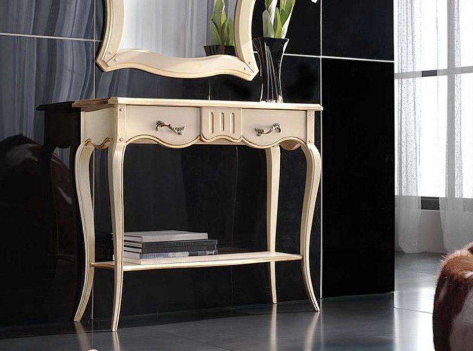 Consolle color crema con due cassetti, un ripiano inferiore e uno specchio su piastrelle nere.