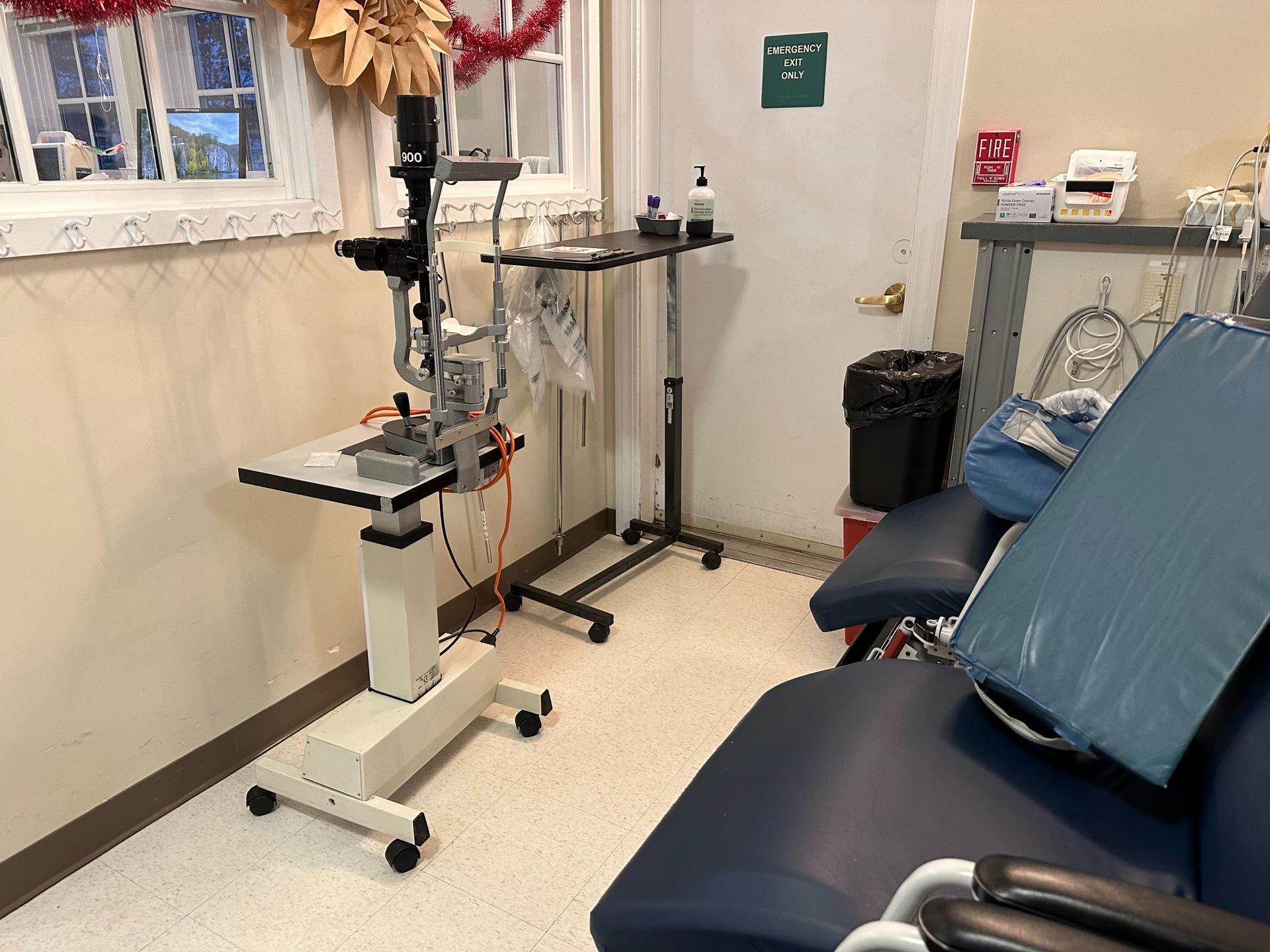A room with a chair and a microscope in it