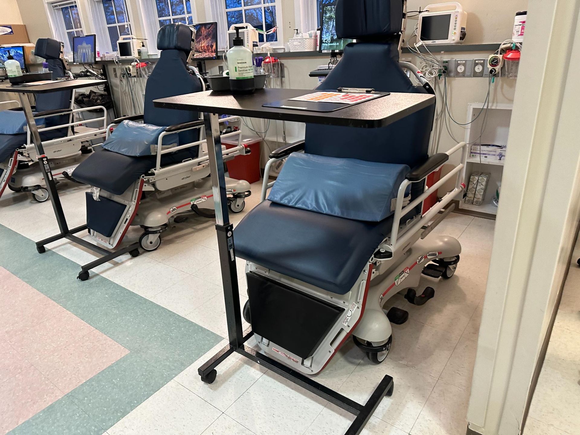 A hospital room with a row of chairs and tables