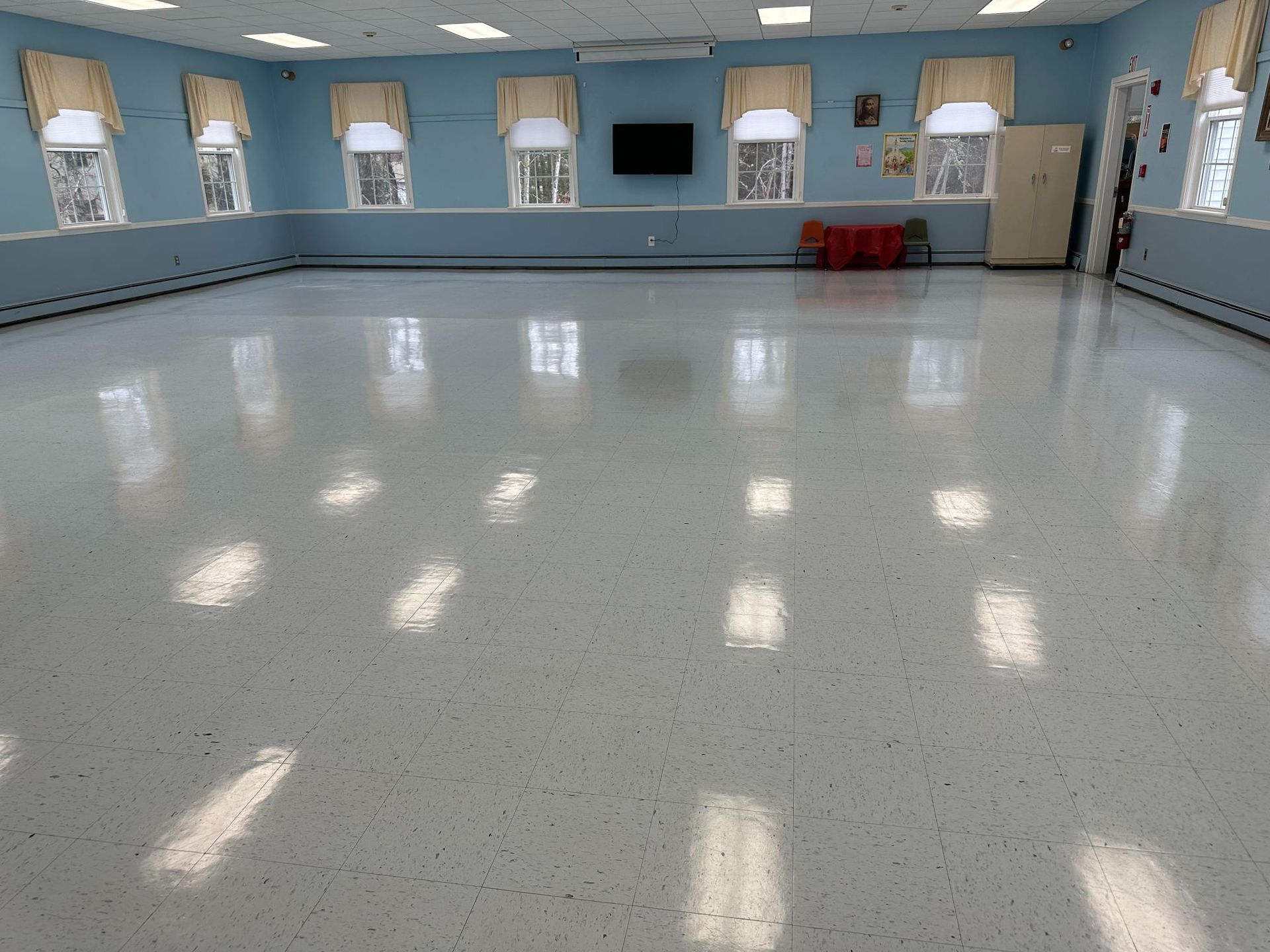 A large room with a white floor and blue walls