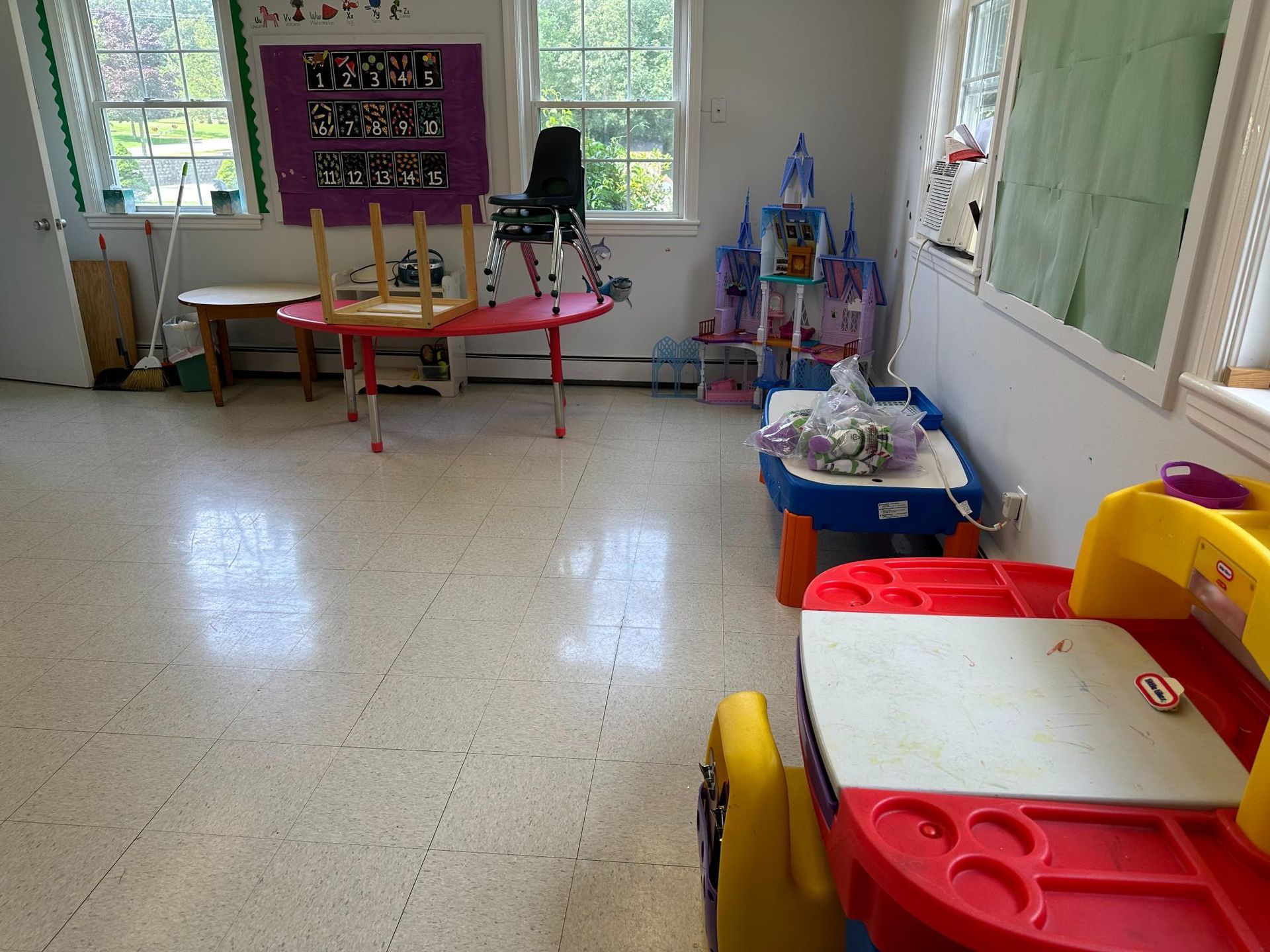 A room with a table and chairs in it