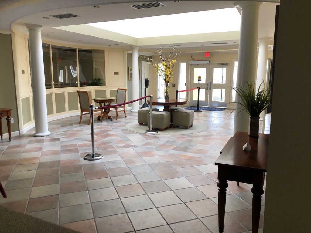 A large room with a table and chairs in it