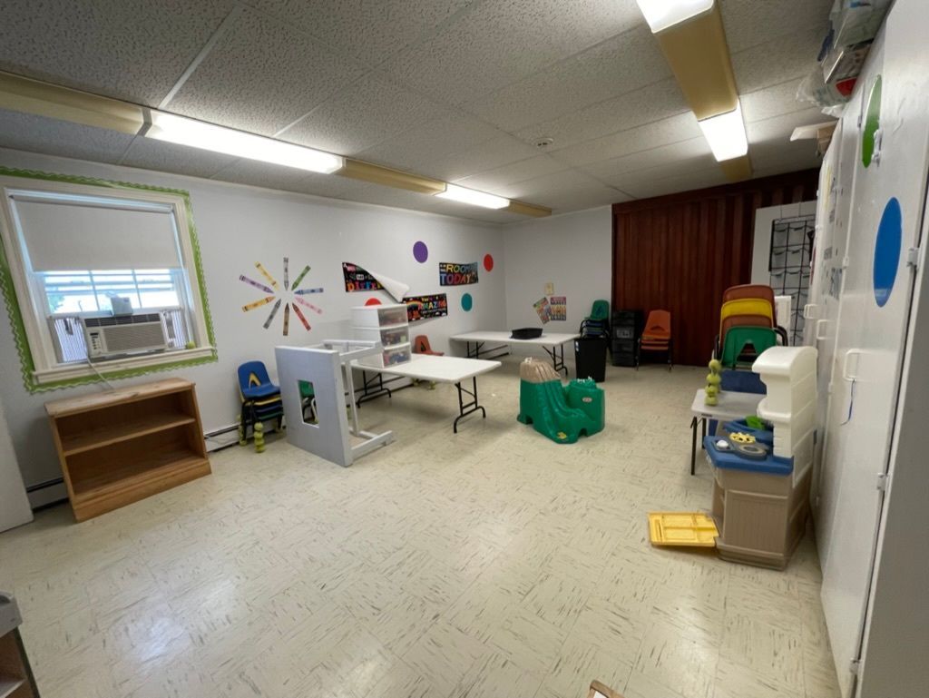 A large room with tables and chairs in it