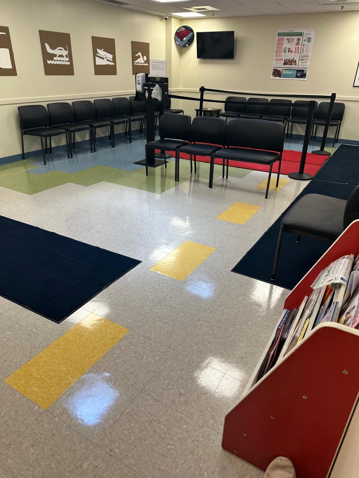 A waiting room with chairs and a magazine rack