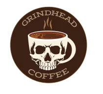 A brown circular logo featuring a skull-shaped coffee mug with steam rising above it, reading "GRINDHEAD COFFEE."
