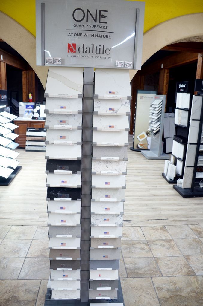 Stack of white boxes in a store aisle beneath a “ONE” sign.