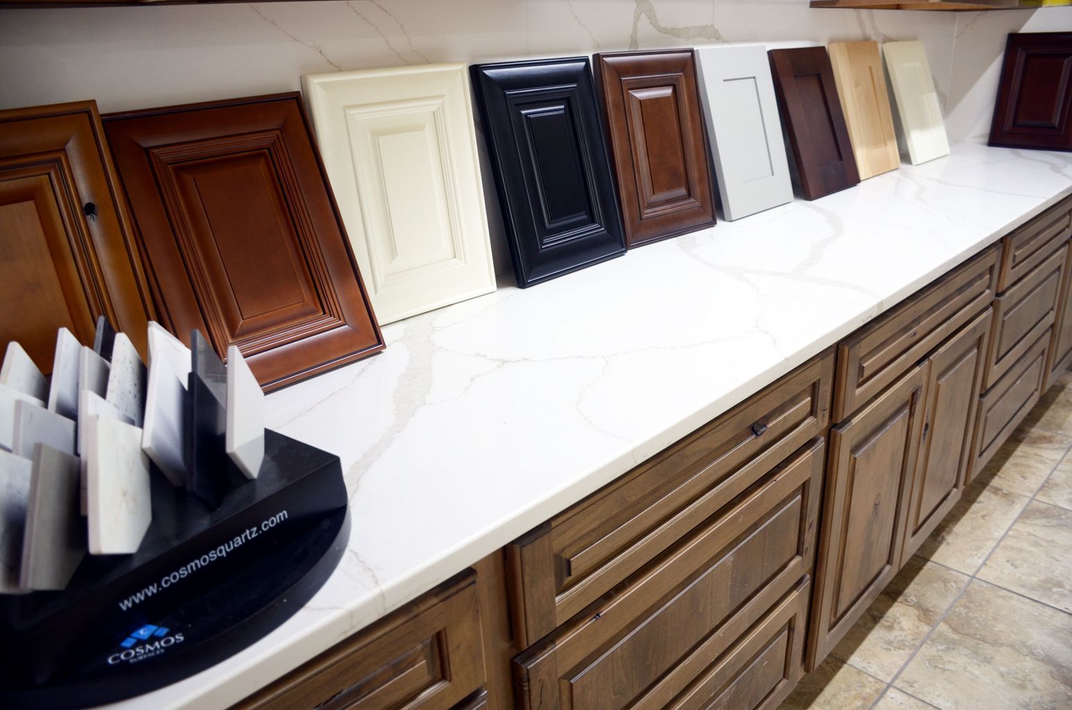 Cabinet door samples displayed on a countertop in a kitchen showroom