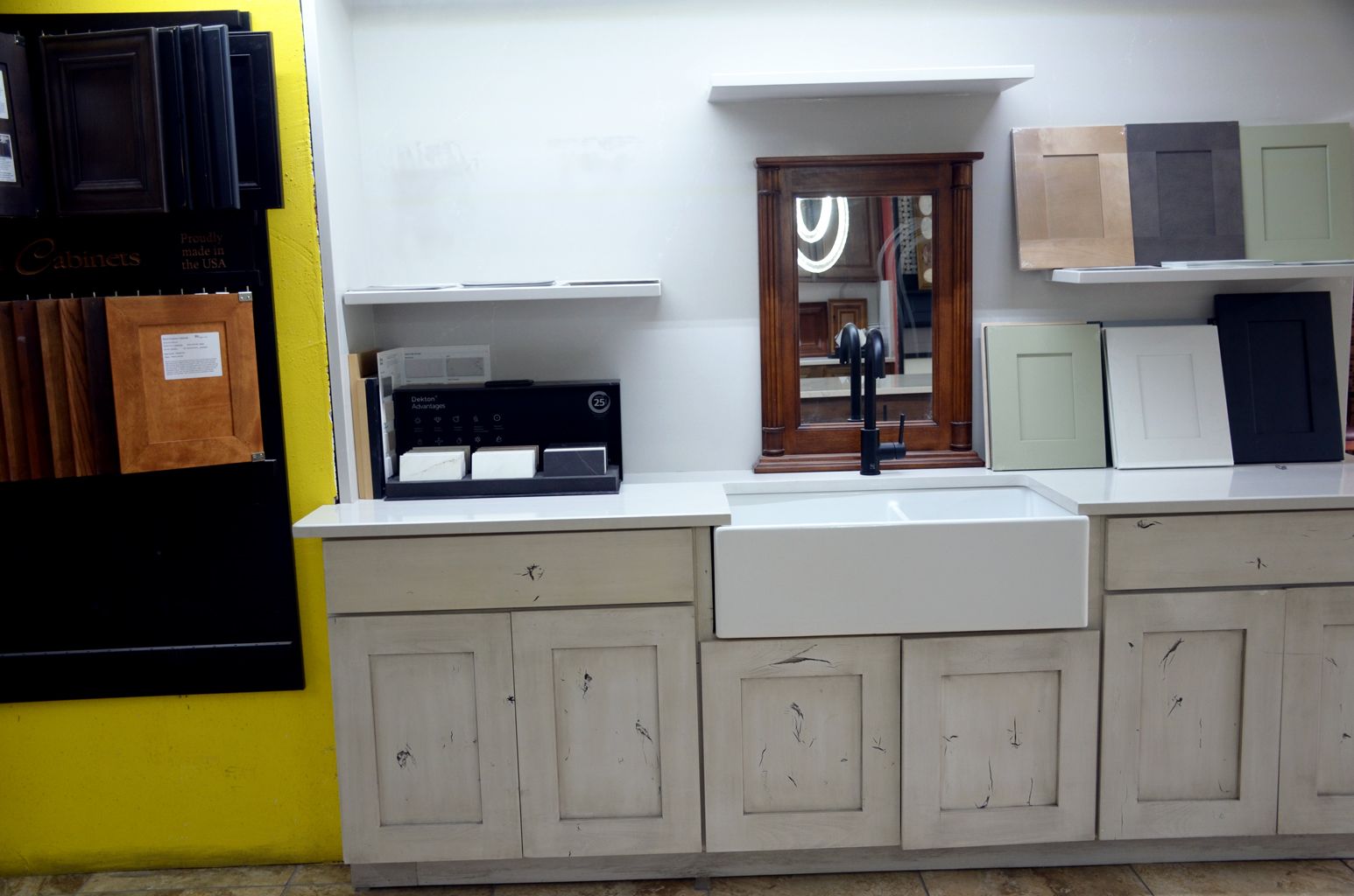 Kitchen counter with sink, cabinets, and shelves, plus a black stove on the left and a window above the sink