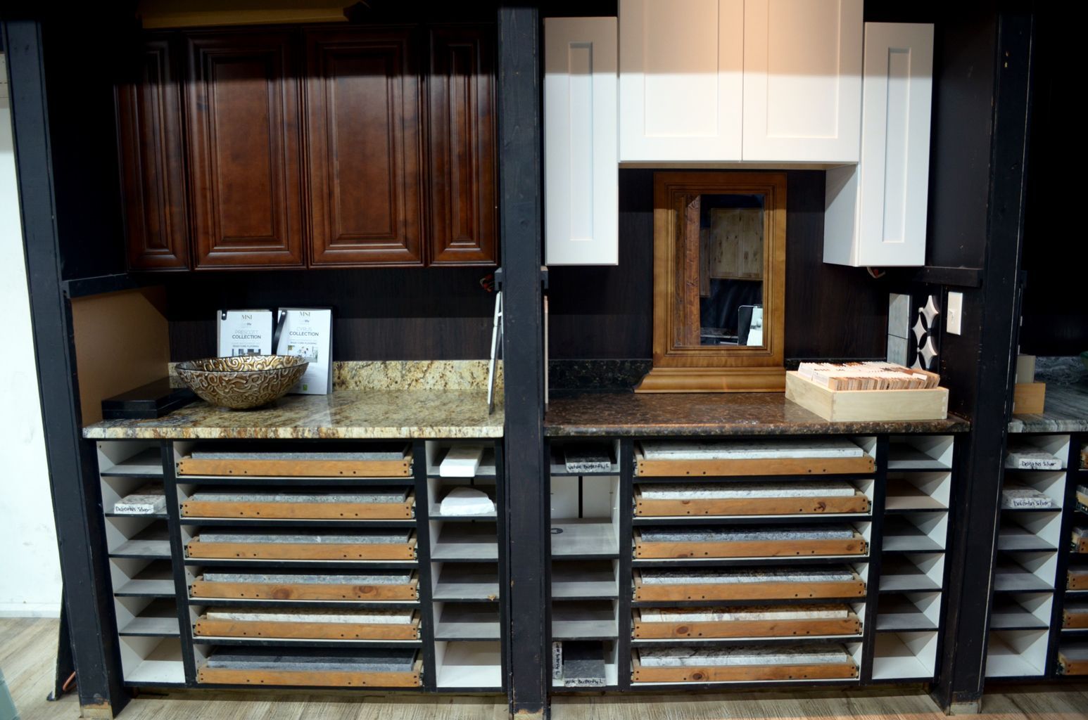 Modern kitchen with dark wood cabinets, granite counters, and many pull-out drawers on both sides of a pass-through window