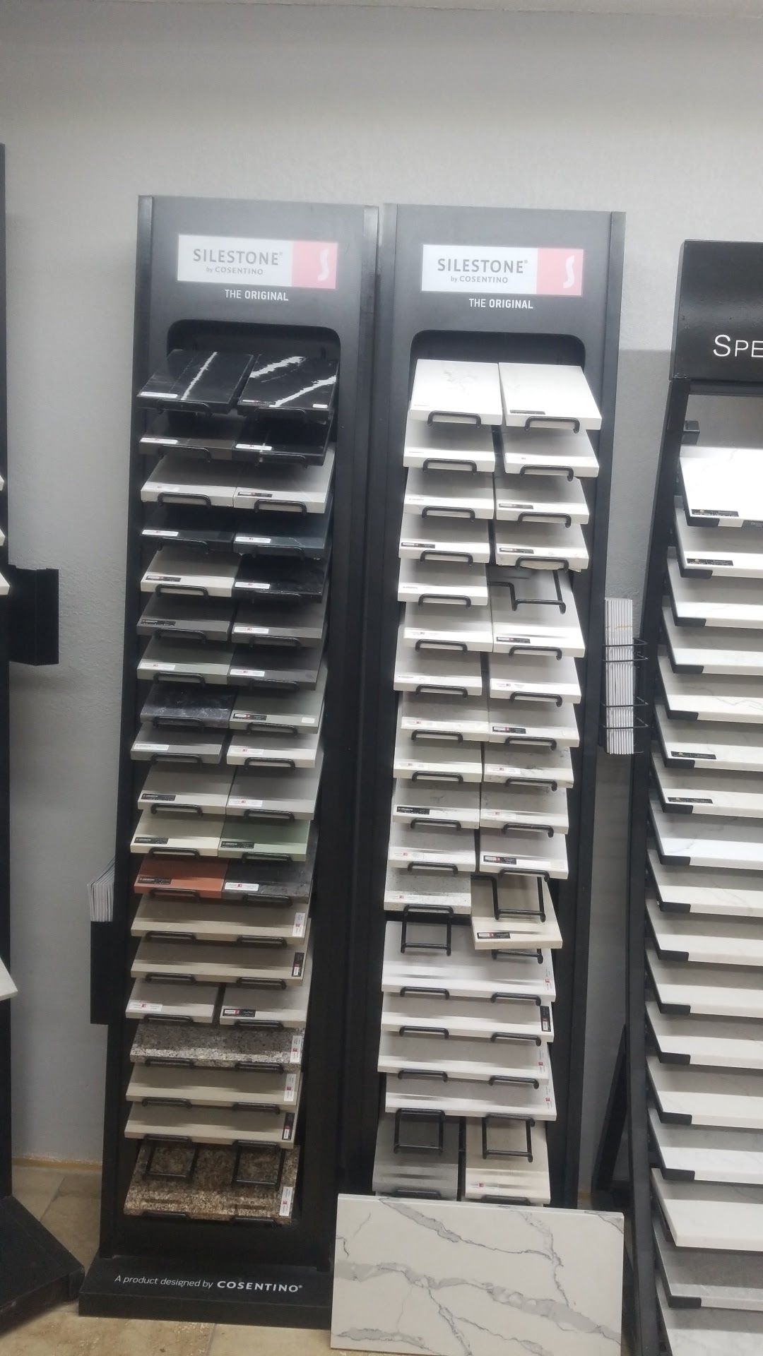 Display rack of black and white sample folders or brochures in a store showroom