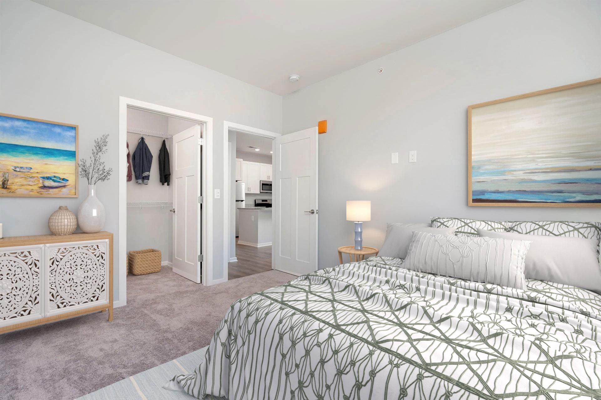 A bedroom with a large bed and a painting on the wall.