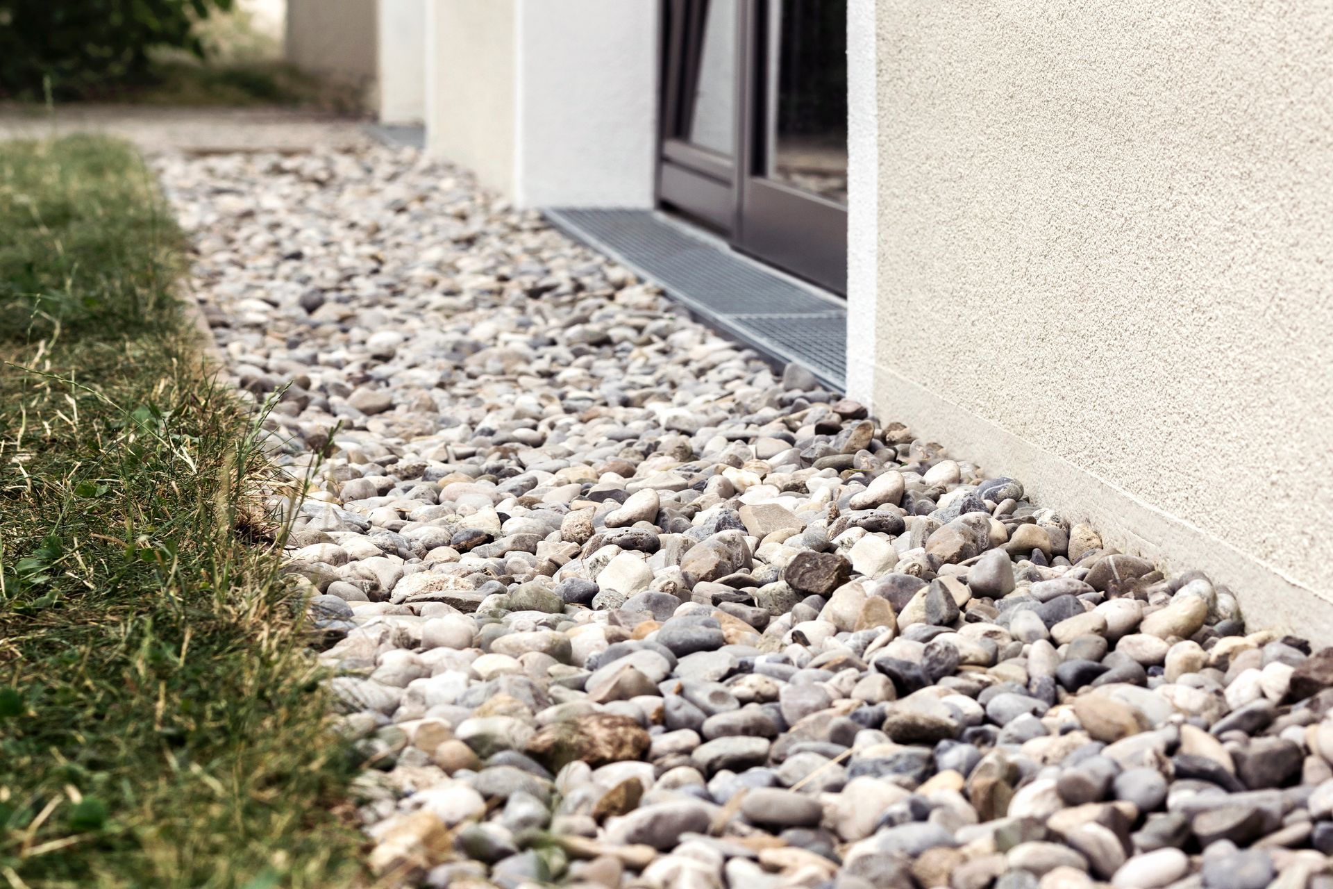 A pile of gravel is sitting in front of a building.