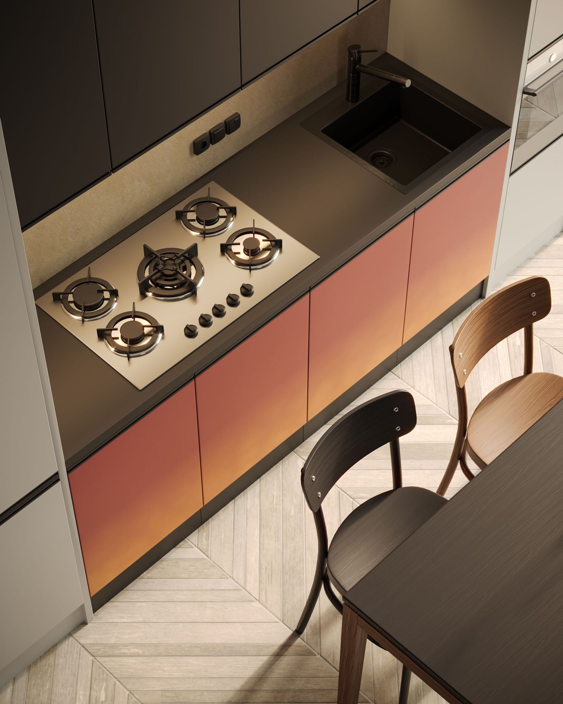Modern kitchen with gas cooktop, sink, cabinets, and dining chairs beside a table.