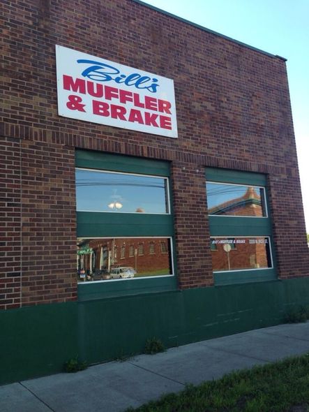 A brick building with a sign that says bill 's muffler and brake
