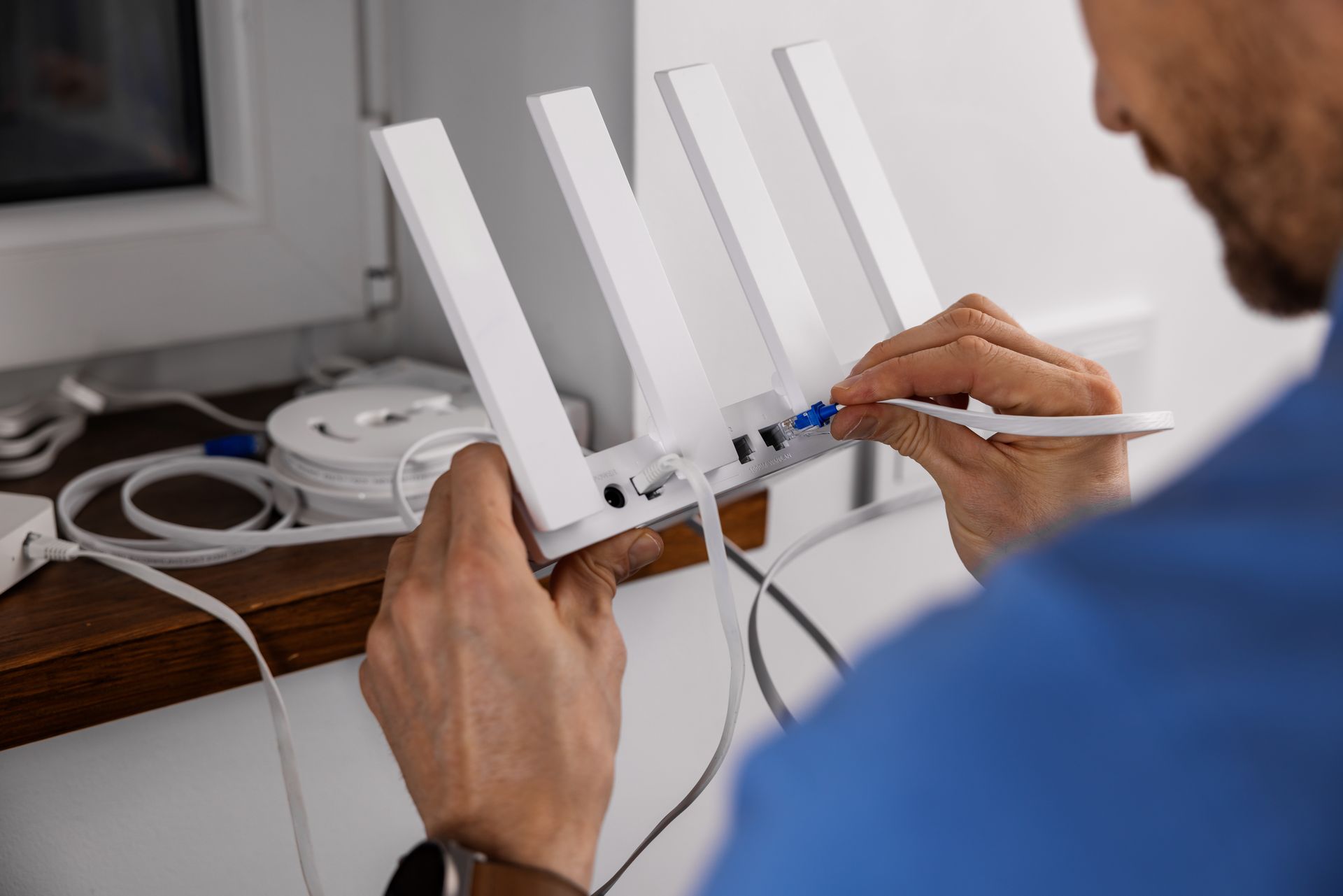 Service technician connecting ethernet cable.