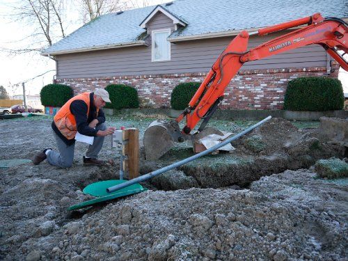 Photo of Dick Gudmunson performing an installation inspection